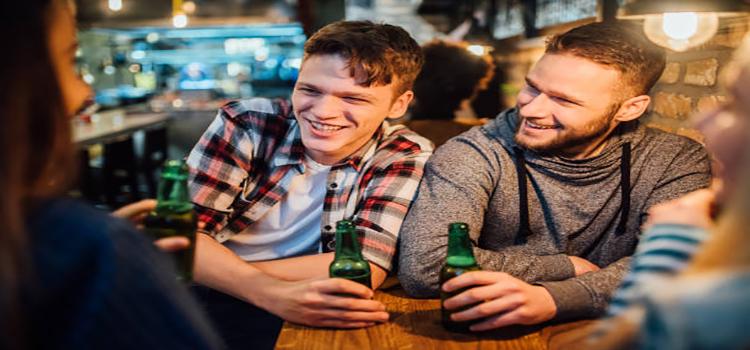 happy young men having a beer together